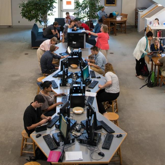 A view from the catwalk in the Portland campus library of students studying in the library