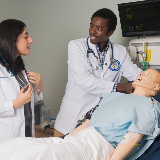 Two osteopathic medicine students in the simulation lab