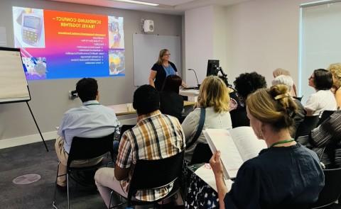 Sally McCormack Tutt lecturing in front of other interprofessional colleagues 